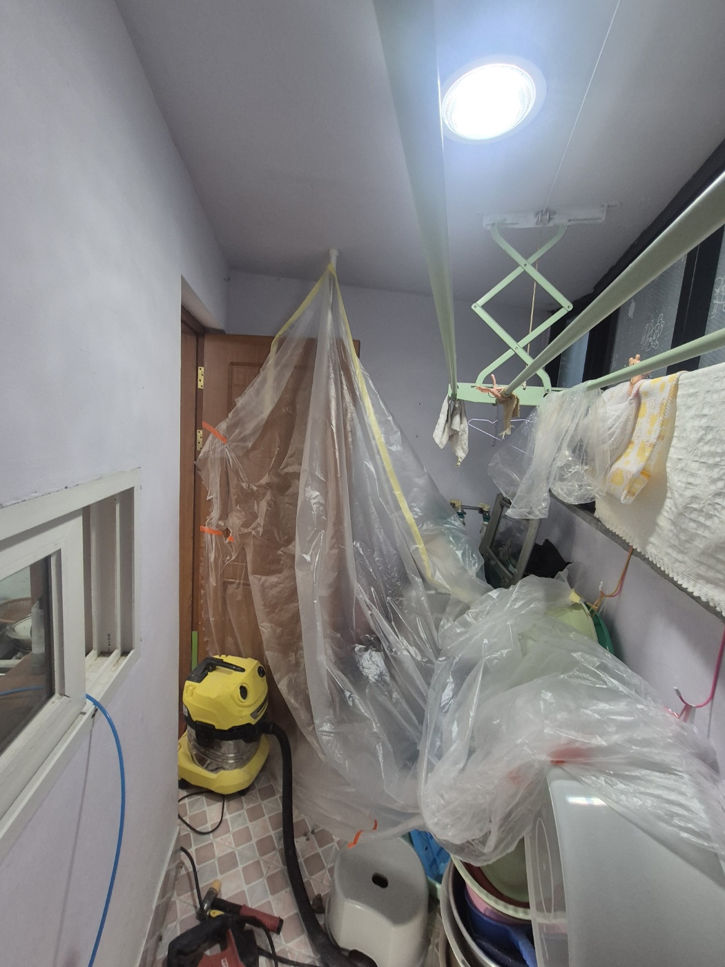 비닐로 주변 물품을 덮은 베란다 작업 공간